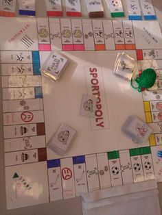 a monopoly board game is displayed on a table with several pieces of paper attached to it