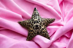 a leopard print star on pink fabric