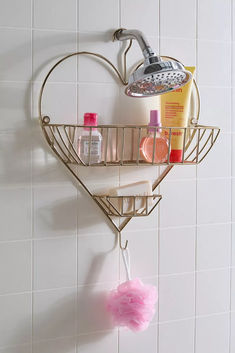 a heart shaped shower shelf with soap, shampoo and lotion