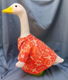 a white duck with an orange dress on it's body