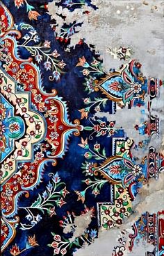 an intricately designed area rug with blue and red colors