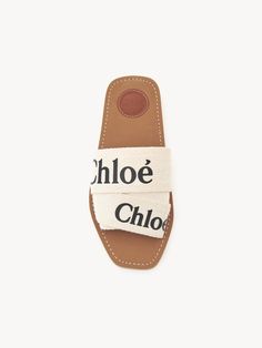 Slides Casual Sandals With Logo Strap For Spring, Casual Summer Sandals With Logo Strap, Summer Beach Slides With Logo, Chic Summer Sandals With Logo, Chic Logo Sandals For Summer, Summer Slip-on Sandals With Logo, Flat Sandals With Logo For Summer, Logo Slip-on Sandals For Summer, Summer Flat Sandals With Logo