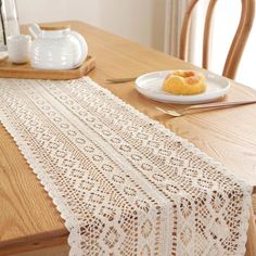 the table runner is made from white crochet