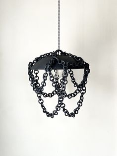 a black chandelier with chains hanging from it