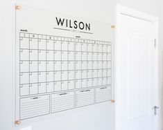 a white wall with a black and white calendar hanging on it's front door