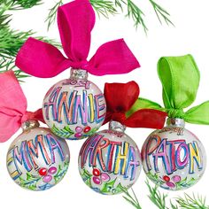 three christmas ornaments with ribbons and bows on them