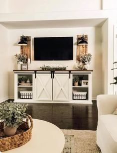 a living room filled with furniture and a flat screen tv mounted to the side of a wall