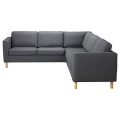 a gray sectional couch with wooden legs on an isolated white background