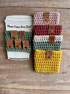 two knitted purses sitting on top of a wooden table next to each other