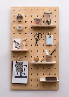 a wooden peg board with various items on it