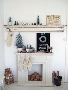 a fireplace with stockings and christmas trees on it's mantel above the mantle