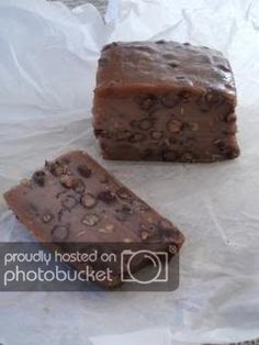 two pieces of chocolate cake sitting on top of white paper