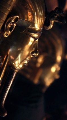 a close up of a gold mask on display