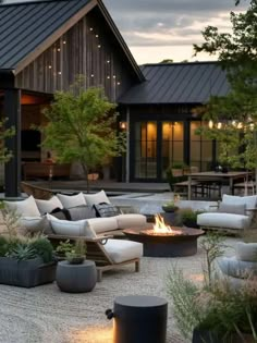 an outdoor living area with couches and fire pit