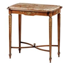 a small wooden table with a marble top and gold trimmings on the legs