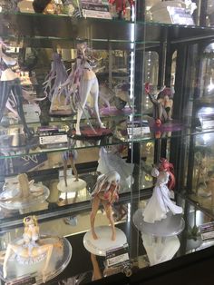 many figurines are on display in a glass case