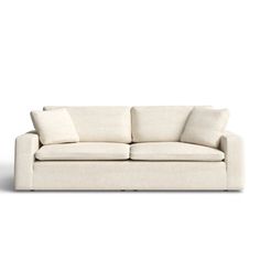 a white couch with two pillows on it