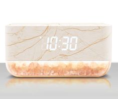 an alarm clock sitting on top of a counter