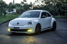 a white volkswagen beetle parked on the street