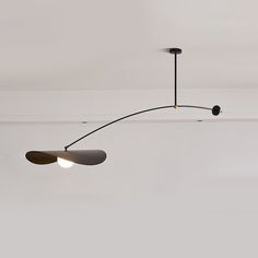 three lights are hanging from the ceiling in a room with white walls and flooring