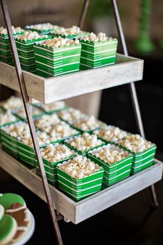 trays filled with popcorn sitting on top of a table next to plates and cups