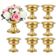 a set of six golden candlesticks with flowers in the center and on each candle holder