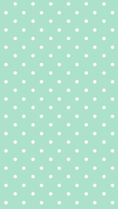 a green background with white polka dots