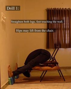 a man is doing a handstand on a chair