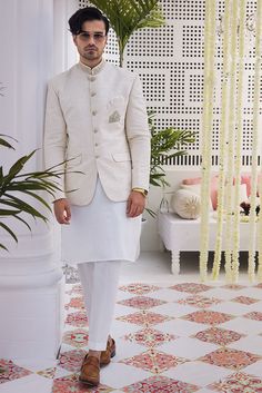 Discover Nehru jackets crafted with intricate embroidery, ideal for cultural events, festivals, and parties. Explore custom options tailored for groomsmen, paired stylishly with sherwanis for a distinguished ensemble.Immerse yourself in the timeless elegance of the off-white jamawar prince coat, meticulously crafted with intricate hand-embroidered details on the collar and a regal motif adorning the front pocket, all accentuated by opulent gold metal buttons. This exquisite garment is a testamen Price Coat For Men For Wedding, White Kurta Pajama Men Weddings, Nikkah Outfit Men, Pakistani Mens Wedding Wear, Prince Coat For Men Wedding, White Prince Coat For Men, Prince Coat Wedding Pakistani, Prince Coat Wedding Pakistani Men, Prince Suit For Men