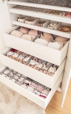 the drawers are filled with different types of shoes and jewelry in white, wooden flooring