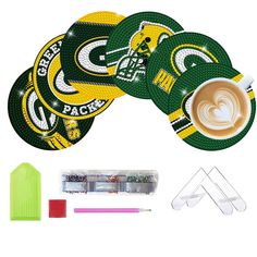 green bay packers coasters, markers and marker pens are arranged in front of a white background