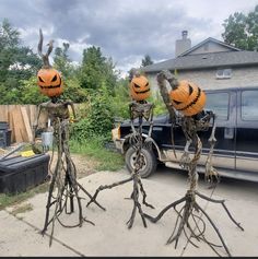 three halloween decorations in the shape of jack - o'- lanterns are on display