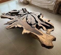 a wooden table sitting on top of a tile floor