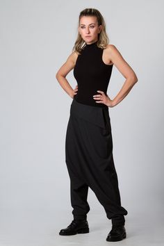 "Harem Pants Women, Black Pants, Drop Crotch Pants This is one of my favorite women's extravagant boho trousers - super comfy drop-crotch lose cut wide-leg tapered at the bottom maxi harem pants. I adore those loose, casual long pants! Handmade from 100% high-quality, excellent cool wool, these pants are an excellent winter, spring, and fall clothing option. KEY FEATURES: - Drop crotch, super loose - Tapered legs - Hidden zipper closure at the hip - Custom size and plus size available at NO EXTR Stretch Wide Leg Harem Pants In Hippie Style, Stretch Wide Leg Harem Pants Hippie Style, High Waist Baggy Harem Pants For Yoga, Hippie Stretch Wide Leg Harem Pants, Baggy Ankle-length Pants For Festival, Stretch Hippie Harem Bottoms, Hippie Stretch Harem Bottoms, Bohemian Stretch Harem Bottoms, Bohemian Stretch Trousers