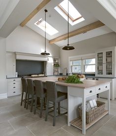 a large kitchen with an island in the middle