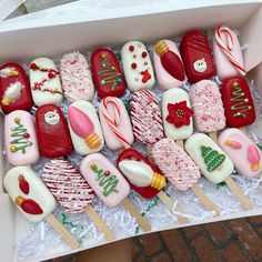 a box filled with lots of different types of candy on top of white lace covered table