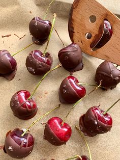 chocolate covered cherries are arranged on a table