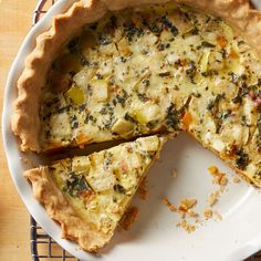 a quiche with cheese and other toppings on a plate