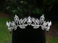 This stunning Tiara Crown is crafted from tarnish resistant zinc alloy and intricately decorated with crystals to create an elegant look ideal for any special occasion, including weddings, quinceañeras, birthdays, pageants and more. **WEARING YOUR CROWN OR TIARA** Most pieces are adjustable by carefully bending and separating the ends to desired fit. Loops are featured in the design for securing to hair with bobby pins or clips **SHIPPING** All orders are sent within 24 hours from Florida, USA. Angelic Crown, Art Deco Crown, Crystal Birthday, Tiara Headpieces, Silver Tiara, Magical Jewelry, Diamond Jewelry Designs, Crystal Crown, Wedding Decor Elegant