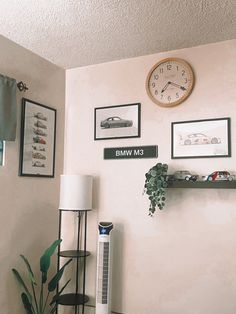 a living room with a clock and pictures on the wall