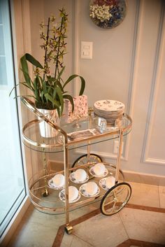 a glass table with plates and cups on it