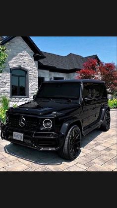 a black mercedes benz truck parked in front of a house with the words, a benz truck