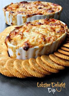 an appetizer dish with crackers on the side and cheese in the middle