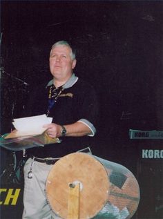 a man sitting on top of a horse next to a microphone