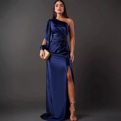 a woman in a blue dress posing for the camera