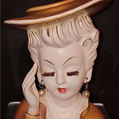 a ceramic statue with a hat on it's head