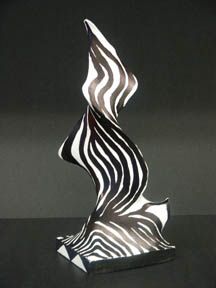 a black and white sculpture sitting on top of a table in front of a dark background