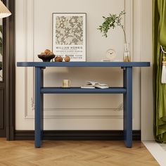 a blue table with some food on it and a plant in the corner next to it