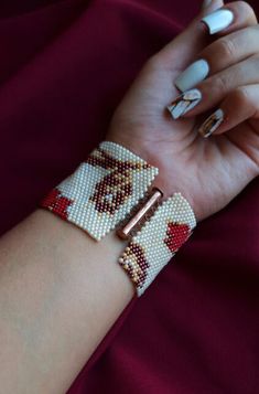 a woman's arm with two bracelets on it and one beaded wrist