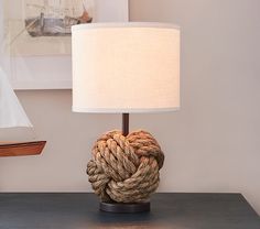 a lamp that is sitting on top of a table next to a roped heart